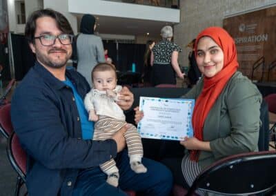 Family celebrating graduation with certificate