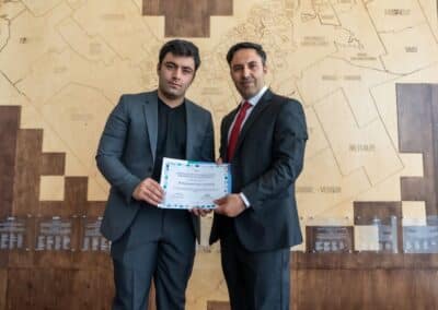 Two men holding a certificate.