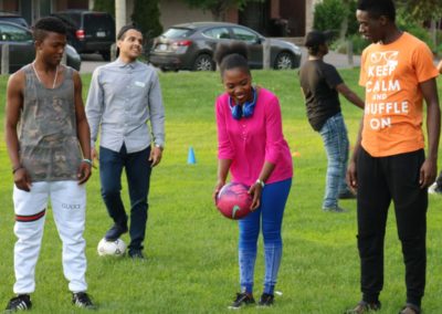 Young people kick around a soccer ball